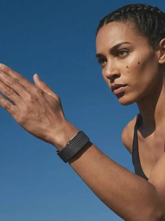 Athletic woman wearing the Hume Band outdoors — building metabolic momentum